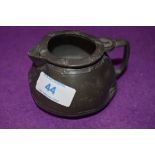 A small antique pewter jug stamped Tudric to base possibly Liberties and co having age related