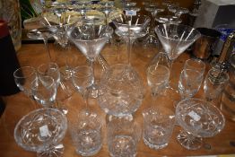 An assortment of glasses including Martini, tumbers ,wine glasses and more.