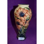 A Moorcroft baluster vase having cream and blue ground with stylised orange flowers.circa 2000.