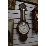 A vintage carved oak bodied barometer with enamel face dial glass AF