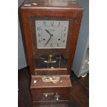 A vintage mahogany cased clocking-in machine, with square dial above the pendulum, mechanism and