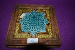 An antique tile framed having aqua blue and green colour way possibly Mintons factory