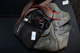 An olympus camera and case.