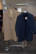Two gents retro/classic raincoats still having tags attached.
