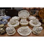 A partial Paragon Victoriana rose dinner service including tureens, plates,bowls, cups and saucers