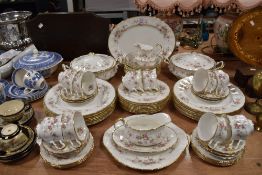 A partial Paragon Victoriana rose dinner service including tureens, plates,bowls, cups and saucers