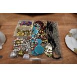 A collection of vintage and modern costume jewellery including clip on earrings and colourful