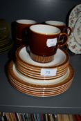 A selection of tea cup trios by Poole pottery having naturalistic glaze