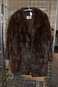 A vintage fur coat having half belt to back.