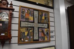 A framed fabric artwork having appliqué and embroidered designs of animals with cross to centre.