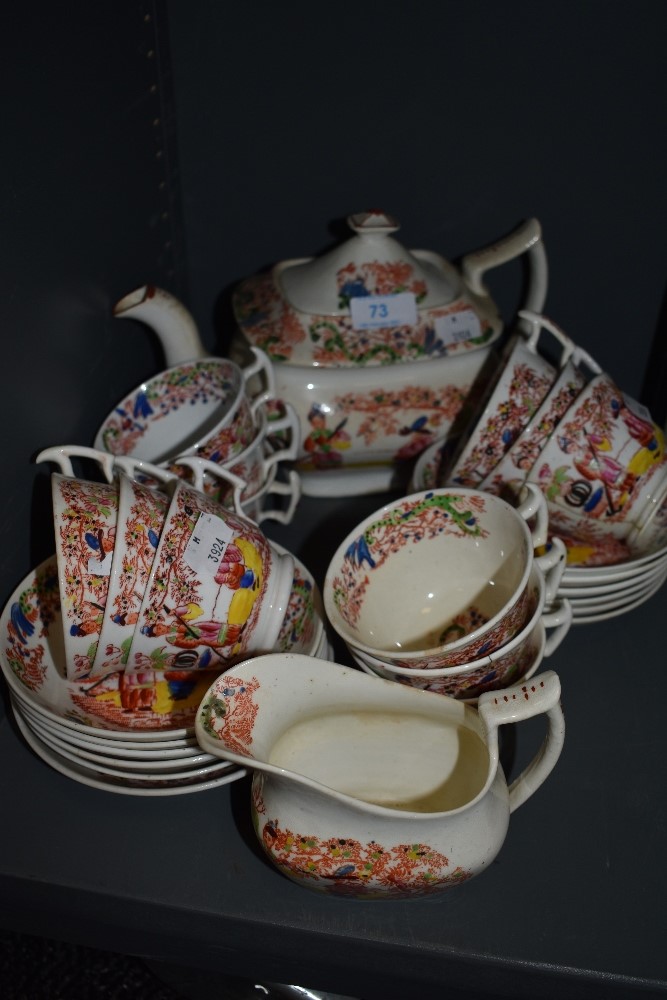 An antique part tea service by Hilditch & Son in a Chinoiserie style with London design tea cups and