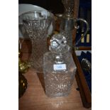 A Stuart crystal vase and two similar decanters one having metal lid and handle.