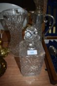 A Stuart crystal vase and two similar decanters one having metal lid and handle.