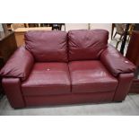 A modern burgundy leatherette two seater settee, width approx. 160cm