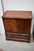 A reproduction mahogany TV cabinet, width approx. 80cm