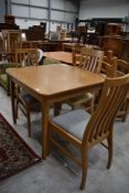 A modern kitchen table and two pairs of chairs