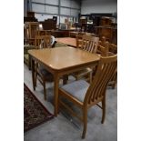 A modern kitchen table and two pairs of chairs