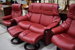 A modern red leather settee, two chairs and two stools suite set by Ekornes Stressless all in very