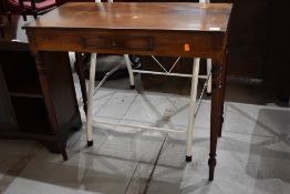 A Victorian mahogany side table having turned legs with dummy frieze drawer