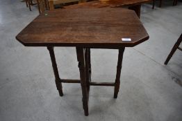 A Victorian mahogany folding table in the campaign style having turned frame, canted top, approx. 60