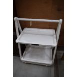 A white plastic folding trolley