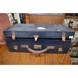 A vintage travel case having leather handle and straps, bearing part label