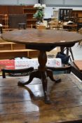 An antique style circular table having once been a tilt top, cut down to coffee table size