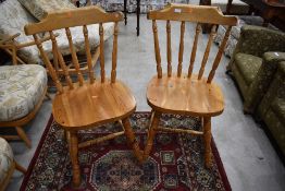 A pair of modern pine kitchen chairs