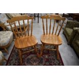 A pair of modern pine kitchen chairs