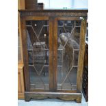 An early 20th Century oak astral glazed bookcase having blind fretwork frieze, width approx. 98cm,