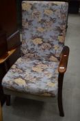 A traditional stained frame upholstered armchair