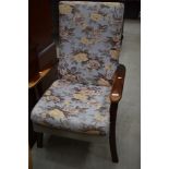 A traditional stained frame upholstered armchair