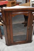 A traditional stained frame corner wall display cupboard