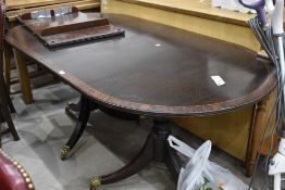 A reproduction Regency extending dining table