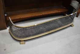 A Victorian brass framed fire fender or guard with pierced metal decoration