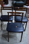 A set of three vintage Danish styled chairs with black vinyl coverings