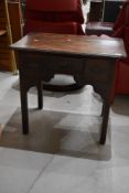 An early 19th Century style low boy , dark stained, possibly Elm top, with some signs of worm, width