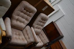 Two modern Ercol wing back arm chairs in a medium stain
