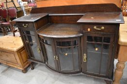 A early 20th Century stained frame break bow front chiffonier base, width approx. 135cm