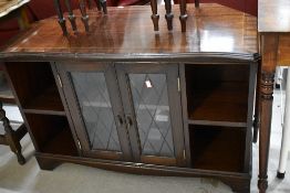A reproduction Regency style low display unit with central display section flanked by shelves,