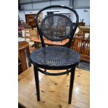 A traditional bentwood cane work chair, in black