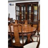 A modern Oriental hardwood bookcase having brass clasps and handles, width approx. 160cm height