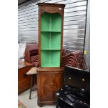 A reproduction Regency style mahogany corner display with open shelves over cupboard, height approx.