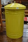 A lime green rubbish bin or trash can