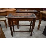 A pair of 19th Century oak side tables having carved vine decoration to top, each approx. 78cm wide,