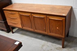 A vintage teak and laminate side board labelled Europa Furniture 150cm long 43cm deep and 74cm