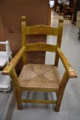 A heavy rush seated carver chair