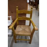 A heavy rush seated carver chair
