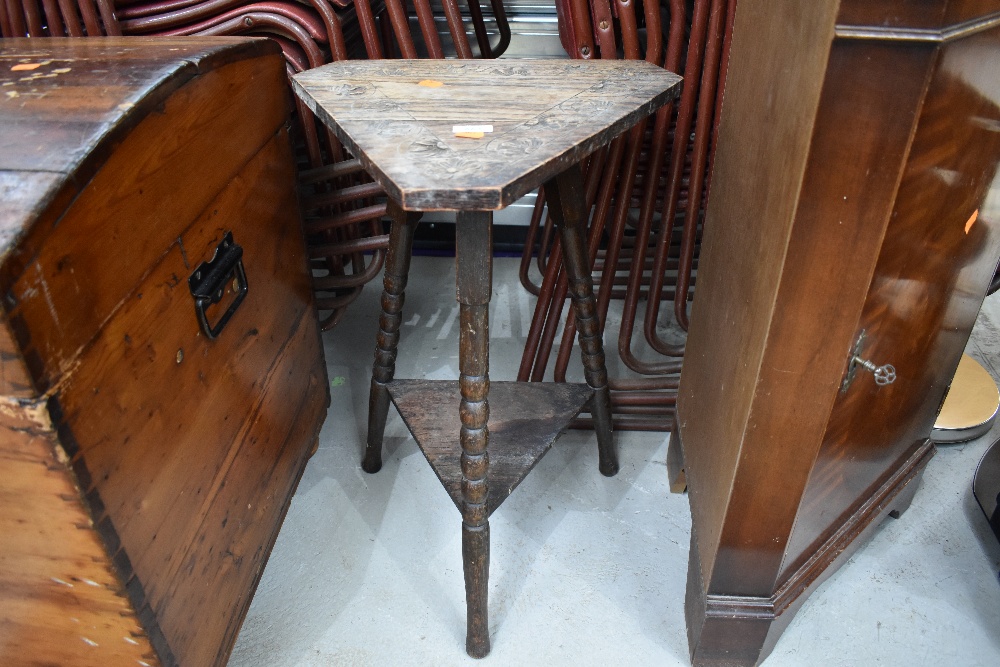 A late 19th/early 20th Century carved tricorn style plant stand/side table on triple turned legs,