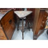 A late 19th/early 20th Century carved tricorn style plant stand/side table on triple turned legs,